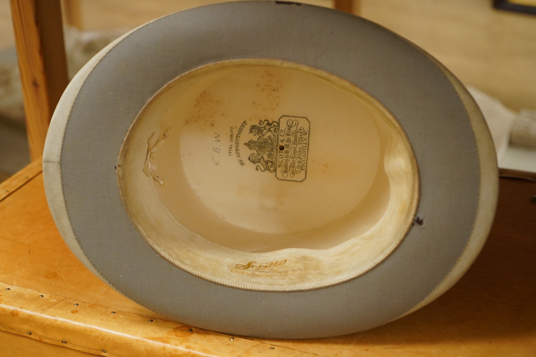 A leather trunk and top hat in box